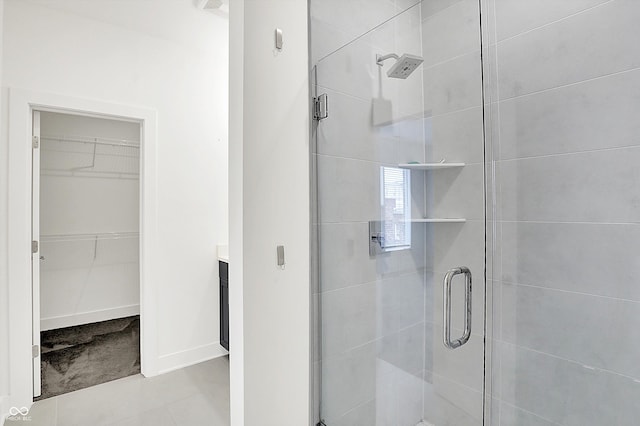 727 N Illinois St Unit 202, Indianapolis, IN 46204 - full bathroom with a shower stall, a spacious closet, vanity, and baseboards