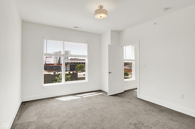 727 N Illinois St Unit 202, Indianapolis, IN 46204 - unfurnished room with plenty of natural light, carpet flooring, baseboards, and a smoke detector