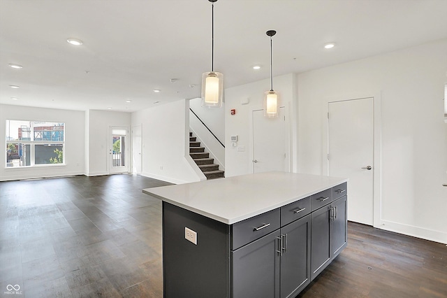 727 N Illinois St Unit 202, Indianapolis, IN 46204 - kitchen featuring dark wood-style flooring, recessed lighting, gray cabinetry, a center island, and light countertops
