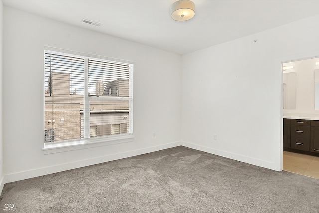 727 N Illinois St Unit 202, Indianapolis, IN 46204 - empty room with healthy amount of natural light, light colored carpet, and baseboards