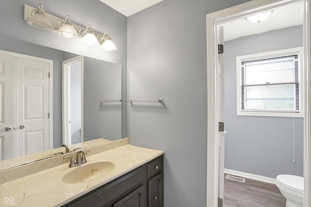 6838 Five Points Rd, Indianapolis, IN 46259 - bathroom featuring vanity, toilet, baseboards, and wood finished floors