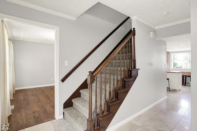 6838 Five Points Rd, Indianapolis, IN 46259 - stairway featuring tile patterned floors, a textured ceiling, baseboards, and ornamental molding