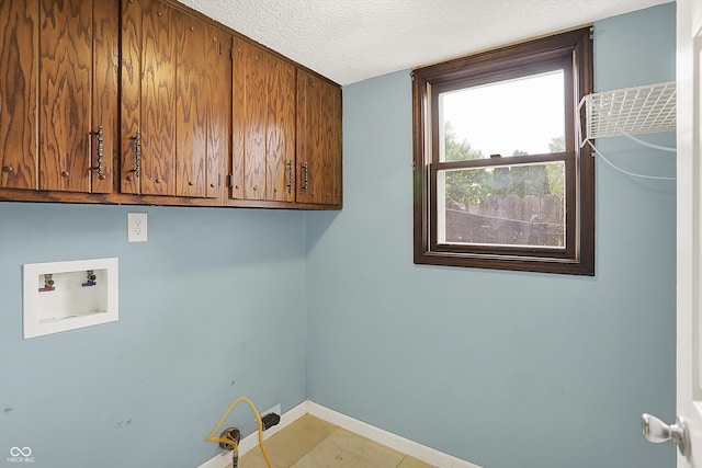 6838 Five Points Rd, Indianapolis, IN 46259 - laundry area featuring cabinet space, hookup for a washing machine, a textured ceiling, and baseboards