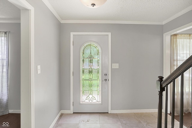 6838 Five Points Rd, Indianapolis, IN 46259 - foyer featuring plenty of natural light, a textured ceiling, light tile patterned floors, baseboards, and crown molding