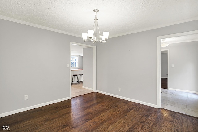 6838 Five Points Rd, Indianapolis, IN 46259 - spare room with a chandelier, wood finished floors, ornamental molding, a textured ceiling, and baseboards