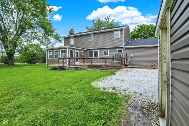 6838 Five Points Rd, Indianapolis, IN 46259 - back of property with a chimney, a lawn, and a wooden deck