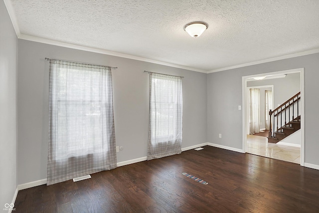 6838 Five Points Rd, Indianapolis, IN 46259 - unfurnished room featuring wood finished floors, a textured ceiling, crown molding, stairs, and baseboards