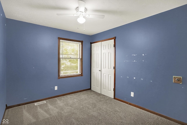 6838 Five Points Rd, Indianapolis, IN 46259 - unfurnished bedroom featuring carpet flooring, a closet, baseboards, and a ceiling fan
