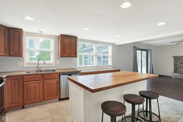 6838 Five Points Rd, Indianapolis, IN 46259 - kitchen featuring a sink, stainless steel dishwasher, a breakfast bar, butcher block counters, and recessed lighting