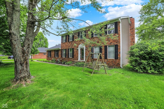6838 Five Points Rd, Indianapolis, IN 46259 - colonial-style house featuring a front lawn, brick siding, and a chimney