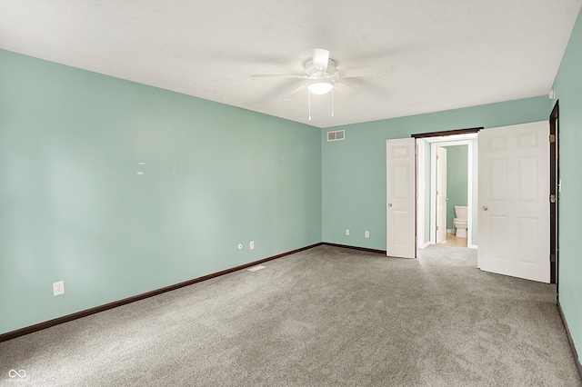 6838 Five Points Rd, Indianapolis, IN 46259 - unfurnished bedroom with carpet flooring, baseboards, connected bathroom, and ceiling fan