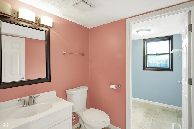 6838 Five Points Rd, Indianapolis, IN 46259 - half bath with a textured ceiling, vanity, toilet, baseboards, and tile patterned floors