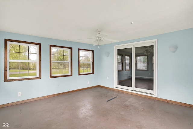 6838 Five Points Rd, Indianapolis, IN 46259 - empty room featuring finished concrete flooring, baseboards, and healthy amount of natural light