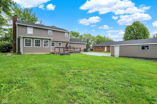 6838 Five Points Rd, Indianapolis, IN 46259 - back of house featuring a chimney, a deck, and a yard