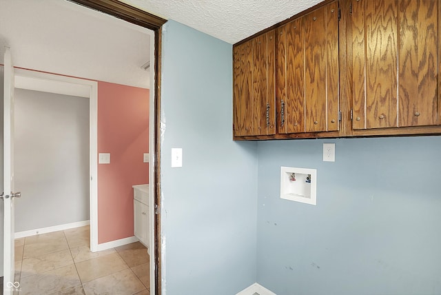 6838 Five Points Rd, Indianapolis, IN 46259 - washroom featuring cabinet space, washer hookup, baseboards, light tile patterned floors, and a textured ceiling