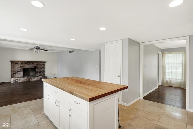 6838 Five Points Rd, Indianapolis, IN 46259 - kitchen with wood counters, a ceiling fan, light tile patterned flooring, white cabinets, and recessed lighting