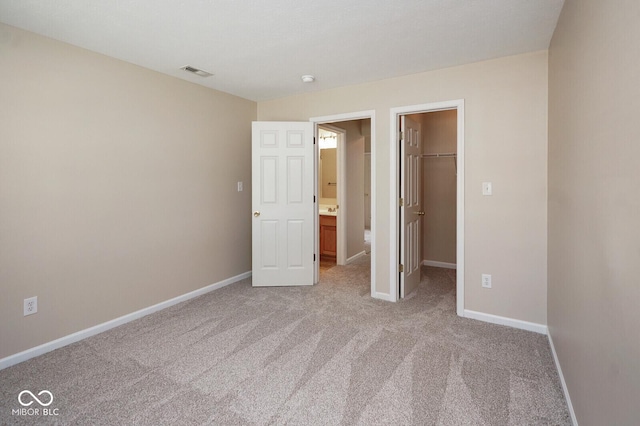 6105 Franklin Villas Way, Indianapolis, IN 46237 - unfurnished bedroom featuring light colored carpet, a walk in closet, baseboards, and a closet