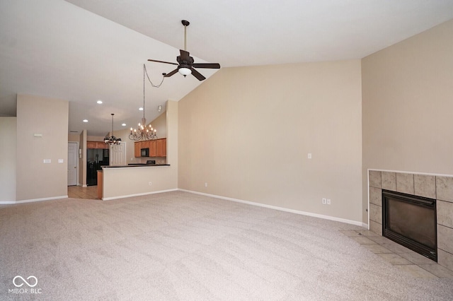 6105 Franklin Villas Way, Indianapolis, IN 46237 - unfurnished living room with ceiling fan, a tile fireplace, lofted ceiling, light colored carpet, and a chandelier