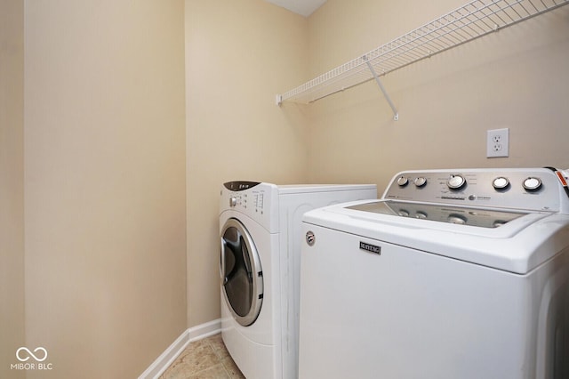 6105 Franklin Villas Way, Indianapolis, IN 46237 - laundry room with washer and dryer, baseboards, and light tile patterned floors