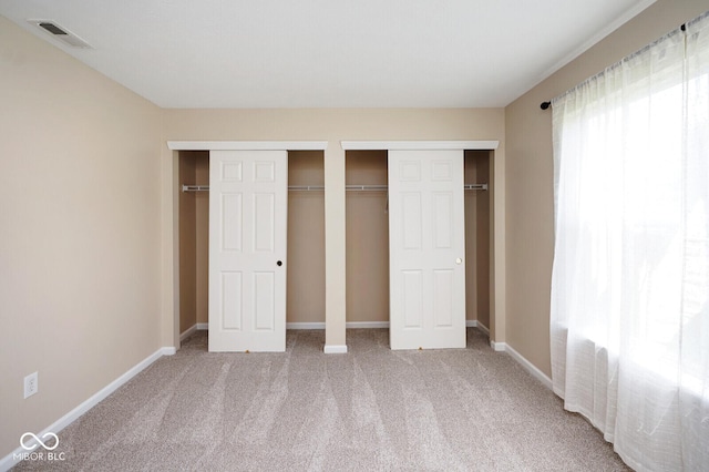 6105 Franklin Villas Way, Indianapolis, IN 46237 - unfurnished bedroom with multiple closets, carpet floors, and baseboards