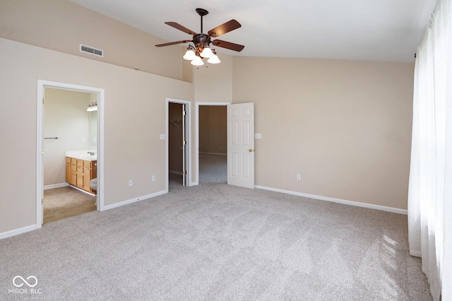 6105 Franklin Villas Way, Indianapolis, IN 46237 - unfurnished bedroom featuring light carpet, a spacious closet, baseboards, ensuite bathroom, and lofted ceiling