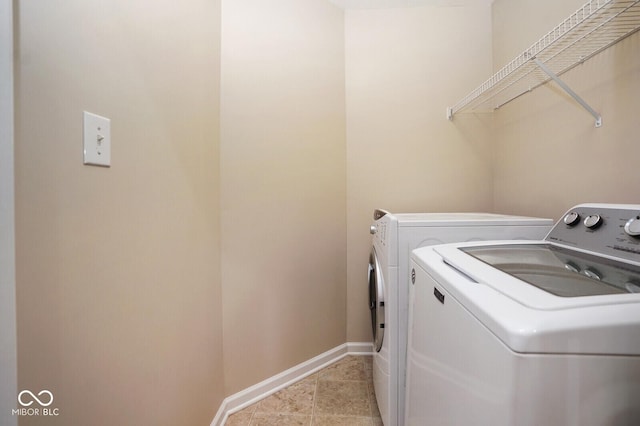 6105 Franklin Villas Way, Indianapolis, IN 46237 - laundry area featuring washer and clothes dryer, baseboards, and light tile patterned floors