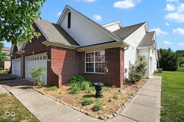 6105 Franklin Villas Way, Indianapolis, IN 46237 - view of front of home with a garage, brick siding, a shingled roof, a front lawn, and asphalt driveway