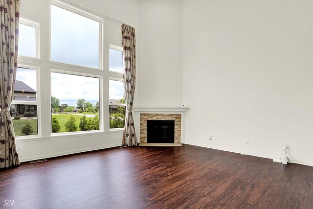 7046 Allegiance Ct, Indianapolis, IN 46259 - unfurnished living room featuring dark wood-style flooring, baseboards, and a fireplace