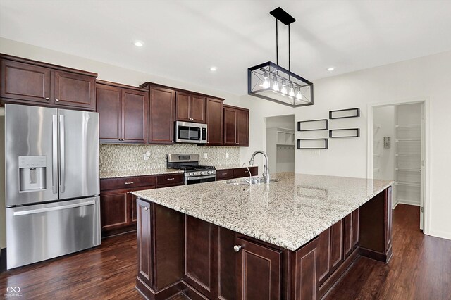 7046 Allegiance Ct, Indianapolis, IN 46259 - kitchen with stainless steel appliances, a sink, dark wood-style floors, decorative backsplash, and light stone countertops