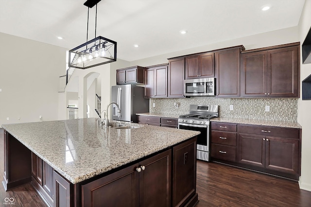 7046 Allegiance Ct, Indianapolis, IN 46259 - kitchen featuring stainless steel appliances, a sink, dark wood-style flooring, light stone counters, and tasteful backsplash