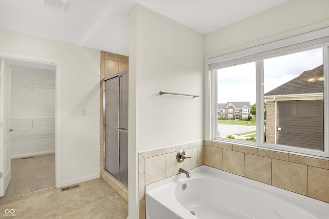 7046 Allegiance Ct, Indianapolis, IN 46259 - full bathroom featuring a garden tub, a stall shower, a walk in closet, and baseboards