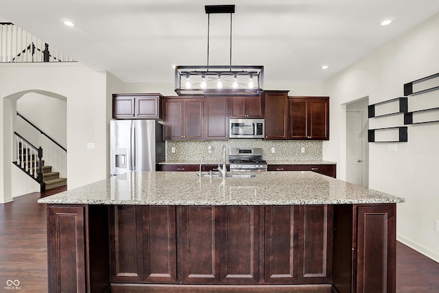 7046 Allegiance Ct, Indianapolis, IN 46259 - kitchen with appliances with stainless steel finishes, a sink, dark wood-style flooring, backsplash, and arched walkways