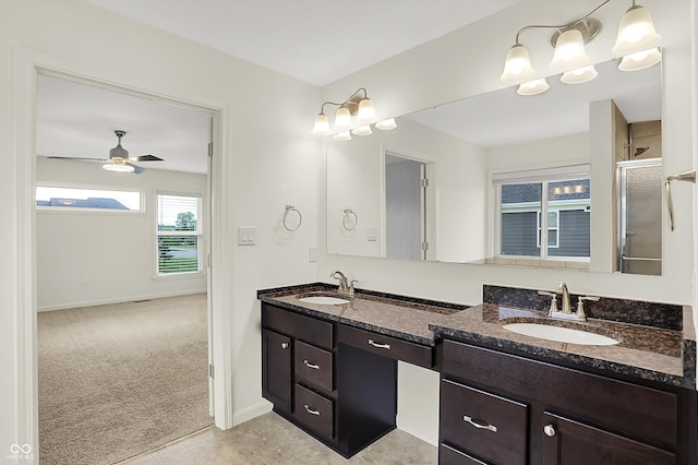 7046 Allegiance Ct, Indianapolis, IN 46259 - bathroom with double vanity, a stall shower, ceiling fan, and baseboards