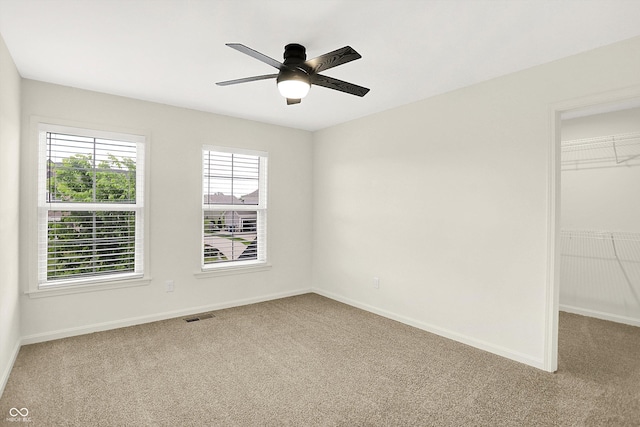 7046 Allegiance Ct, Indianapolis, IN 46259 - unfurnished bedroom featuring carpet floors, a walk in closet, and baseboards