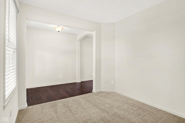 7046 Allegiance Ct, Indianapolis, IN 46259 - empty room with carpet floors, arched walkways, and baseboards