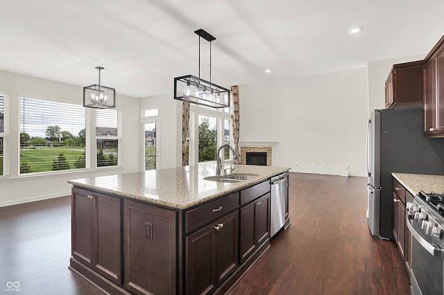 7046 Allegiance Ct, Indianapolis, IN 46259 - kitchen with a sink, a chandelier, stainless steel appliances, dark wood finished floors, and recessed lighting