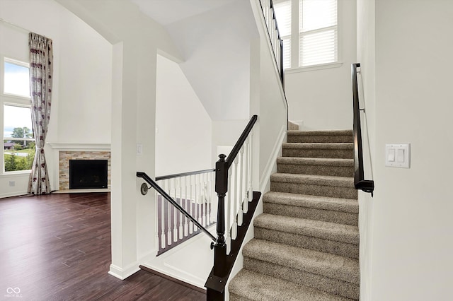 7046 Allegiance Ct, Indianapolis, IN 46259 - stairs featuring wood finished floors, baseboards, and a fireplace