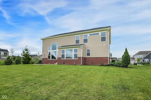 7046 Allegiance Ct, Indianapolis, IN 46259 - back of house featuring a lawn and brick siding