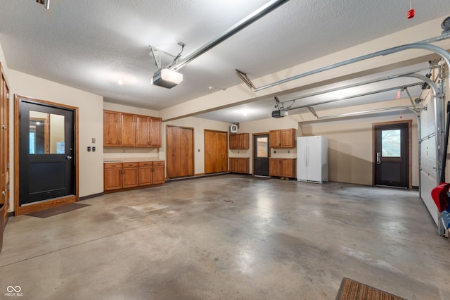 2411 N County Road 500 W, Muncie, IN 47304 - garage with freestanding refrigerator and a garage door opener