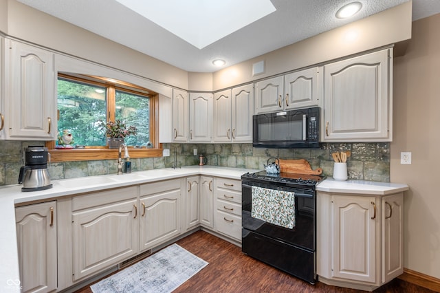 2411 N County Road 500 W, Muncie, IN 47304 - kitchen featuring black appliances, dark wood-style floors, and light countertops