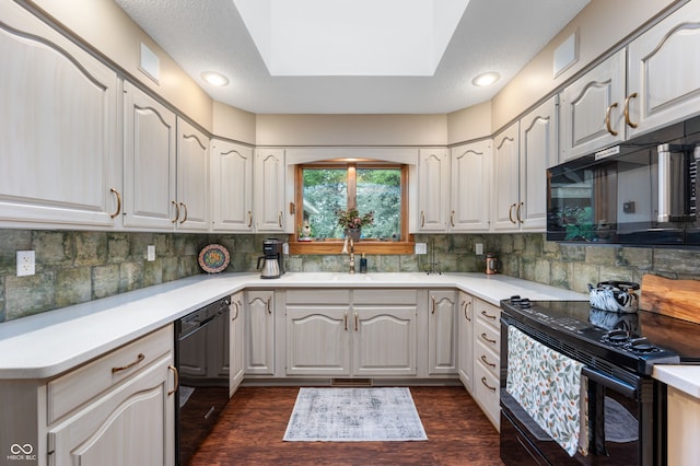 2411 N County Road 500 W, Muncie, IN 47304 - kitchen with black appliances, a sink, dark wood-type flooring, tasteful backsplash, and light countertops