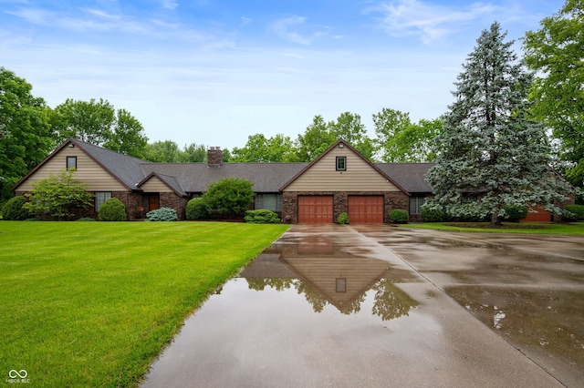 2411 N County Road 500 W, Muncie, IN 47304 - view of front of property with driveway, a garage, a chimney, and stone siding