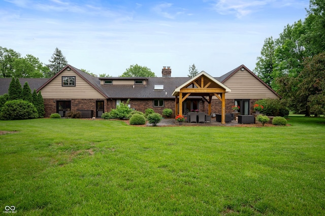 2411 N County Road 500 W, Muncie, IN 47304 - view of front of property with a front yard, a chimney, brick siding, and a patio area
