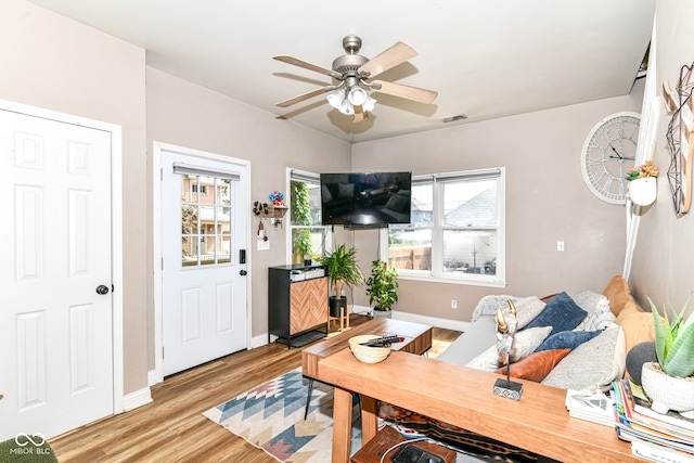 635 E 10th St, Indianapolis, IN 46202 - living room featuring wood finished floors, ceiling fan, and baseboards