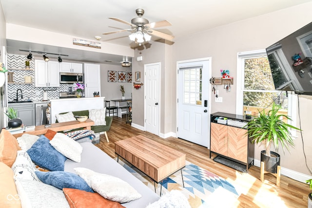 635 E 10th St, Indianapolis, IN 46202 - living area with a ceiling fan, light wood-type flooring, and baseboards