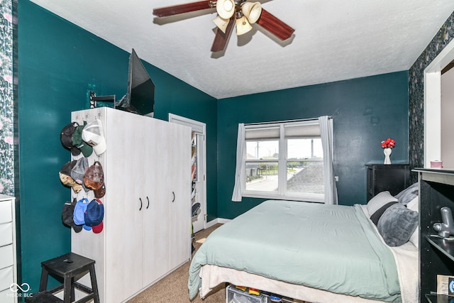 635 E 10th St, Indianapolis, IN 46202 - carpeted bedroom featuring a textured ceiling, ceiling fan, and baseboards