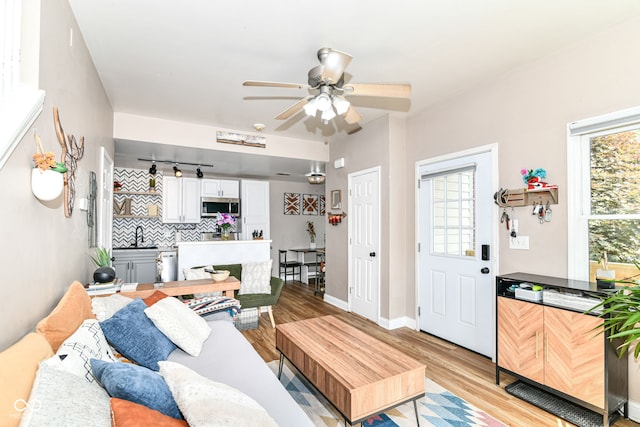 635 E 10th St, Indianapolis, IN 46202 - living room with ceiling fan, light wood-style flooring, and baseboards