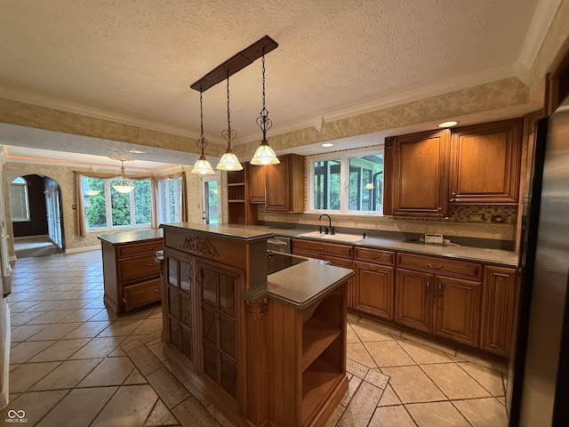 6609 N Tuxedo Ln, Indianapolis, IN 46220 - kitchen featuring open shelves, a center island, plenty of natural light, a textured ceiling, and ornamental molding