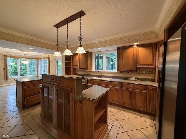 6609 N Tuxedo Ln, Indianapolis, IN 46220 - kitchen with open shelves, a center island, a sink, healthy amount of natural light, and crown molding