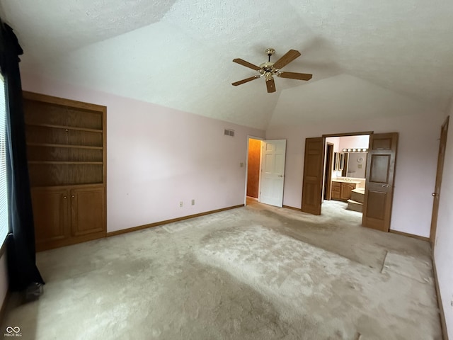 6609 N Tuxedo Ln, Indianapolis, IN 46220 - unfurnished bedroom featuring lofted ceiling, light carpet, baseboards, ensuite bath, and a ceiling fan